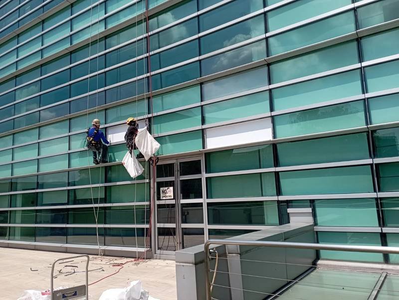 Façade glass installation at height by Skyline Rope Tech in Singapore