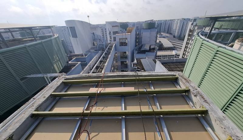 Metal roof works at height on a live Singapore building
