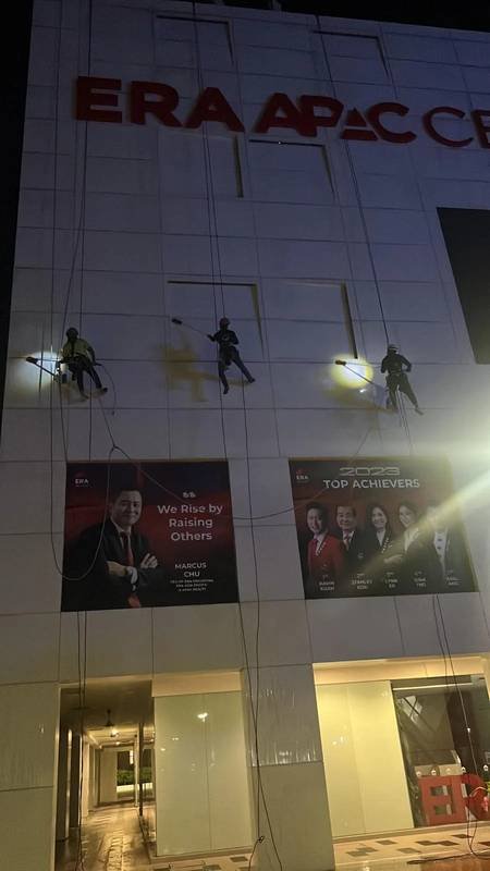 Skyline Rope Tech rope access team cleaning an occupied commercial façade in Singapore